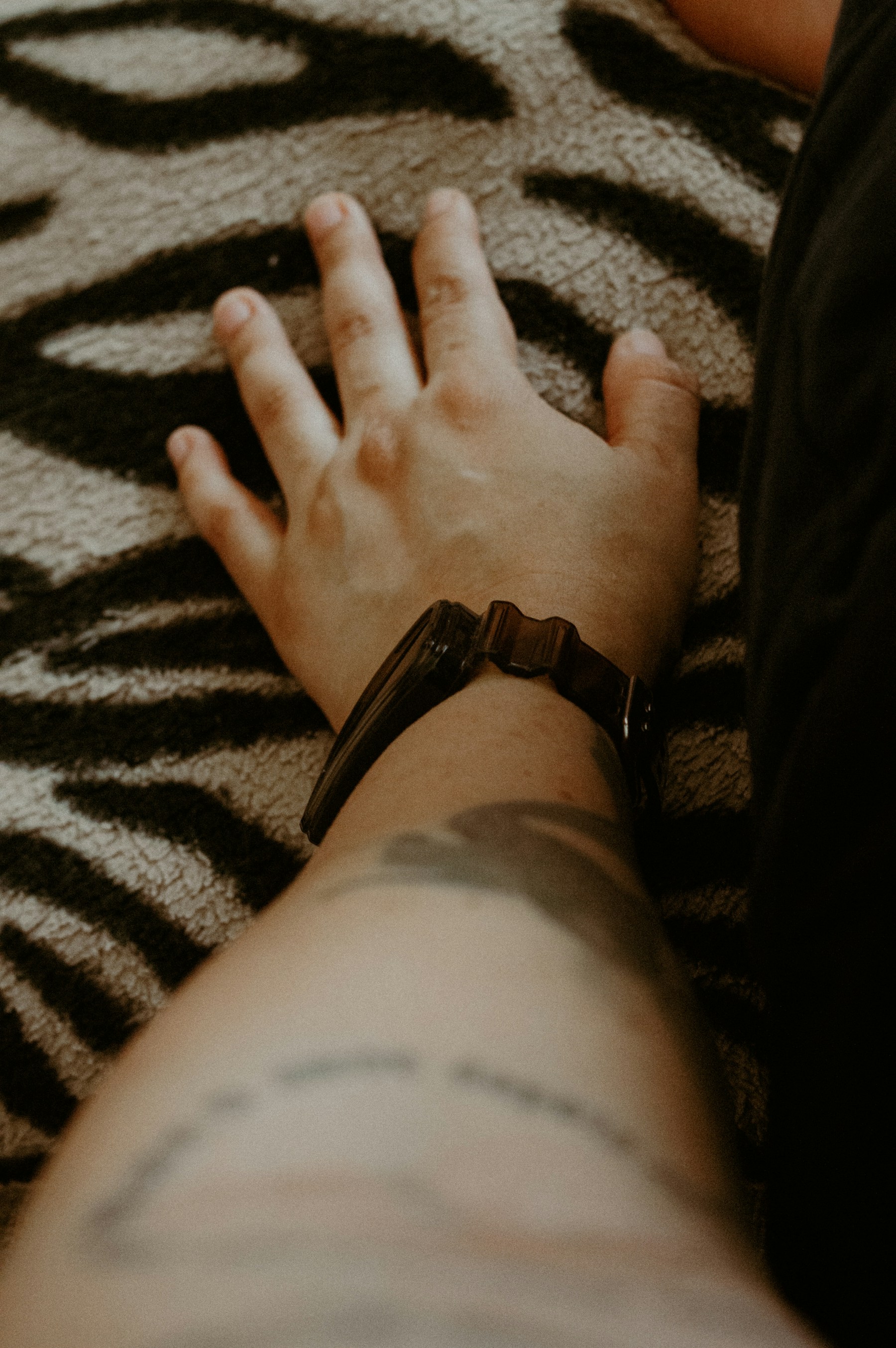A close view of a tattooed arm and wristwatch
