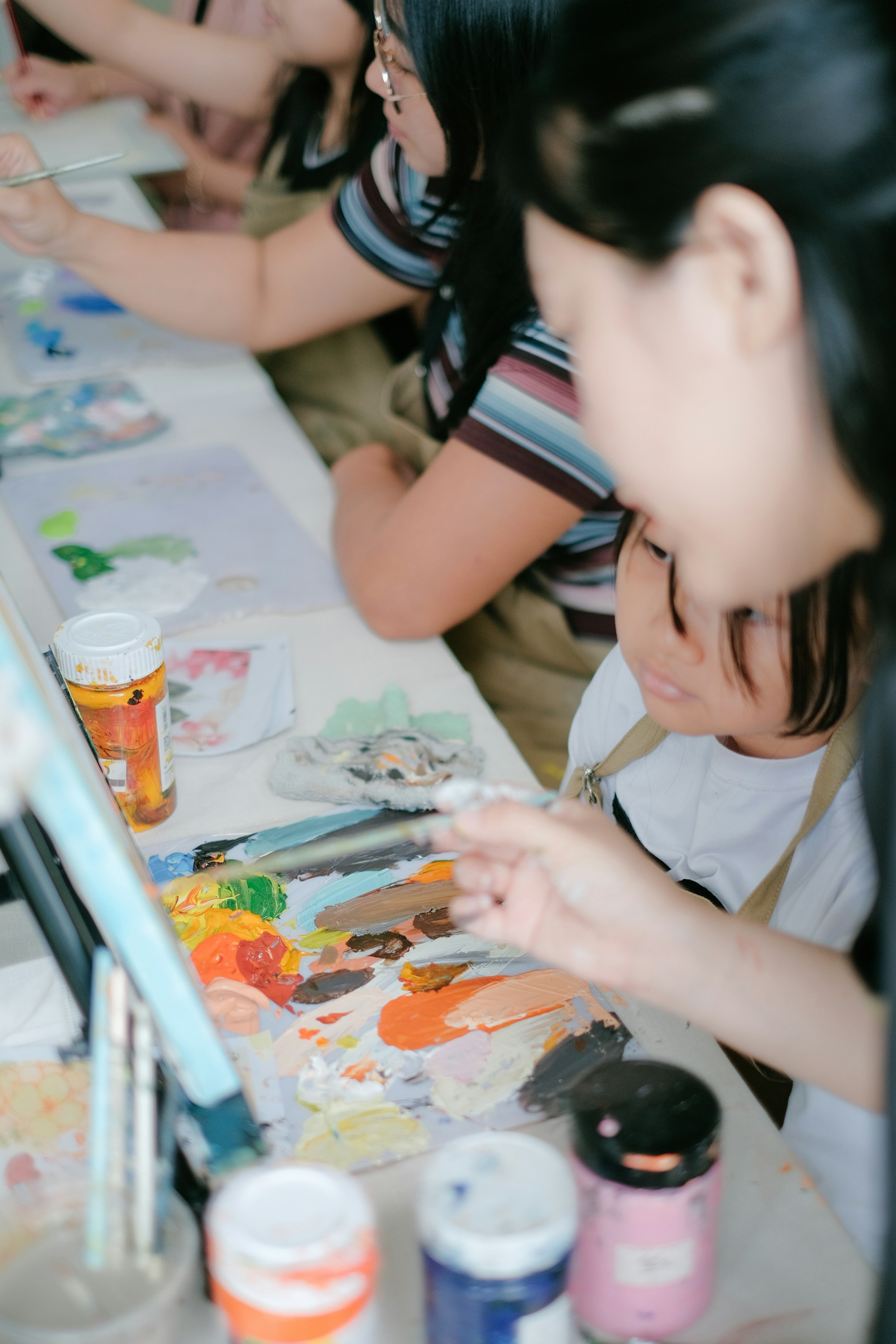 People sharing a table while painting together